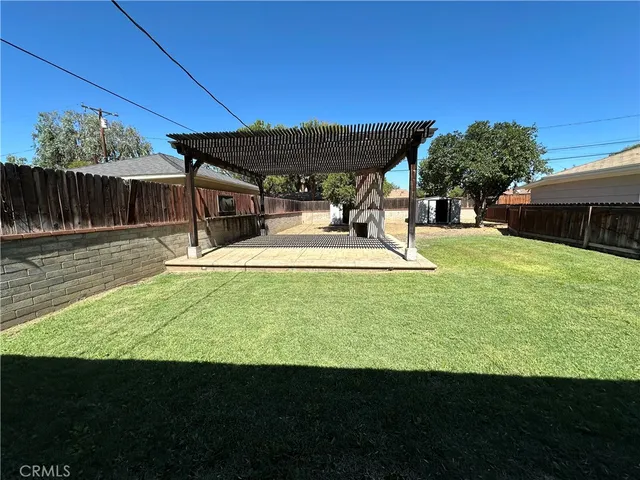 a view of a backyard with plants and patio