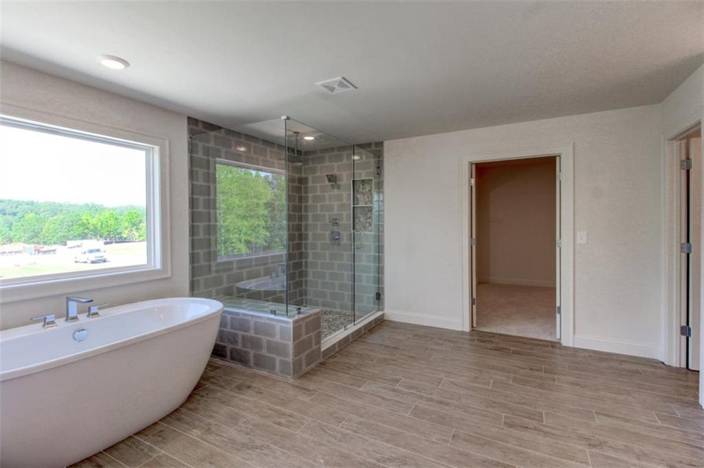 3055 Reserve Court Southwest Conyers, GA 30094 - Photo 29 of 33 a spacious bathroom with a large tub and shower
