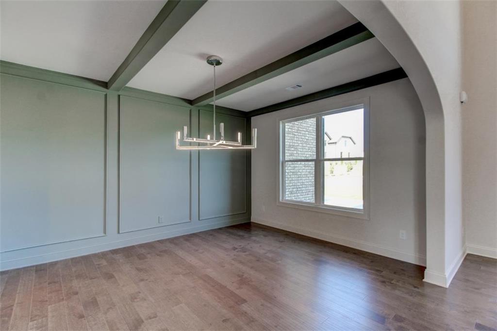 3055 Reserve Court Southwest Conyers, GA 30094 - Photo 6 of 33 an empty room with wooden floor and windows