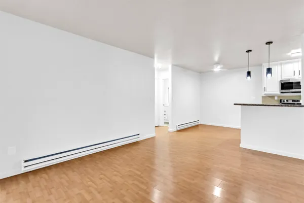 a view of a kitchen with a sink and a refrigerator