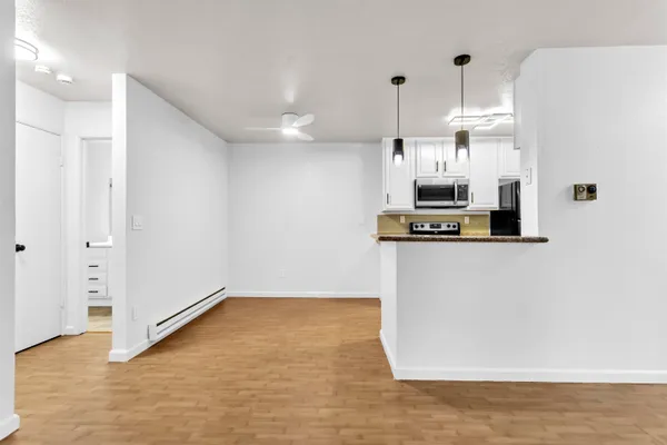 a kitchen with kitchen island a counter top space a sink and appliances