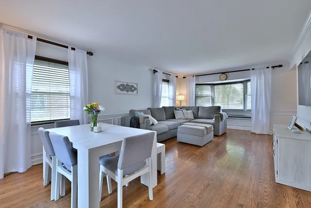 a view of a dining room with furniture and wooden floor