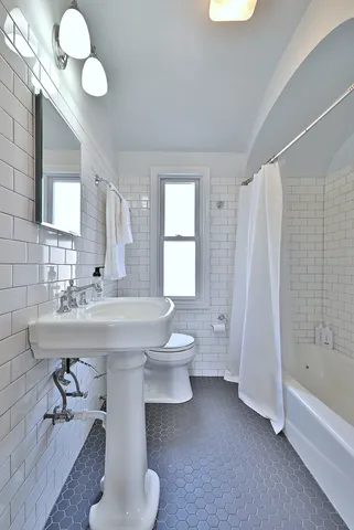 a bathroom with a sink a toilet and bathtub