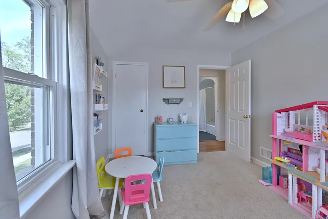 a bedroom with furniture and a window