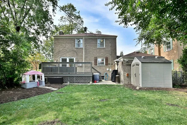 a view of a house with a yard and sitting area
