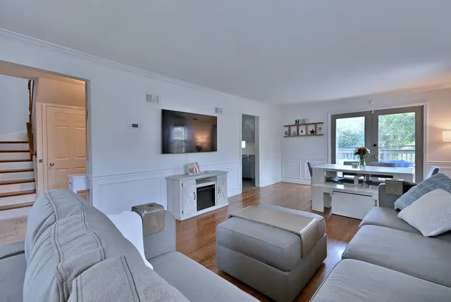 a living room with furniture fireplace and flat screen tv