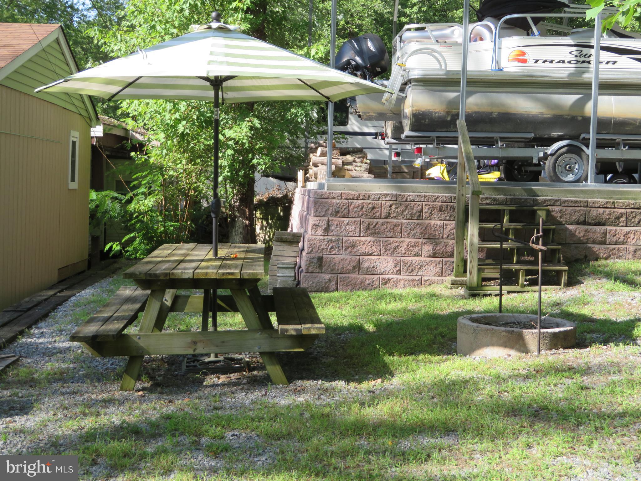 79-6 & 79-7 Detour Road Falling Waters, WV 25419 - Photo 7 of 29 Picnic & Fire Pit Area **Pontoon Does NOT Convey**