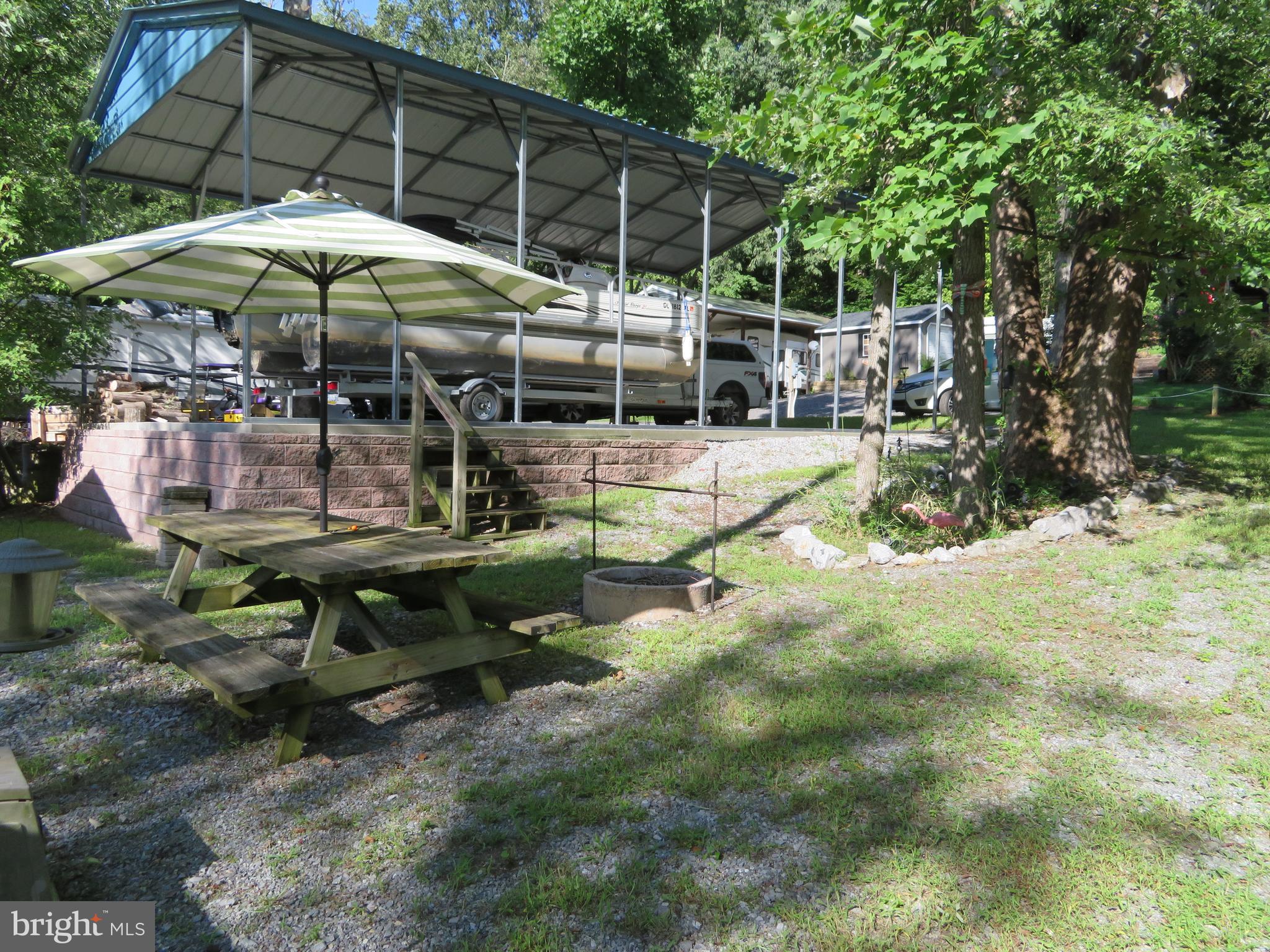 79-6 & 79-7 Detour Road Falling Waters, WV 25419 - Photo 10 of 29 Picnic & Fire Pit Area **Pontoon Does NOT Convey**