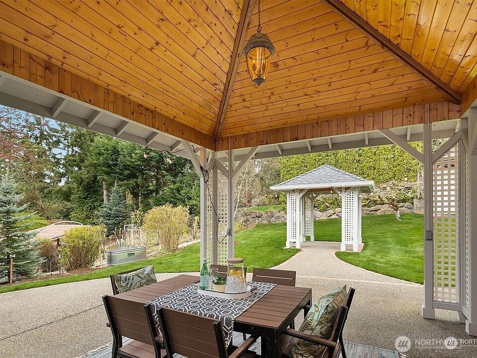 405 240th Street Southwest Bothell, WA 98021 - Photo 14 of 29 a view of a patio with table and chairs under an umbrella