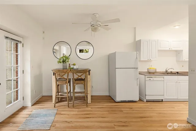a view of a kitchen with cabinets and wooden floor