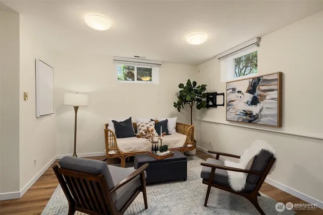 a living room with furniture and wooden floor