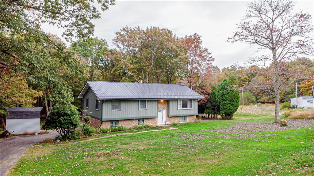 3794 Chestnut Ridge Road Blairsville, PA 15717 - Photo 1 of 26 a front view of a house with a garden