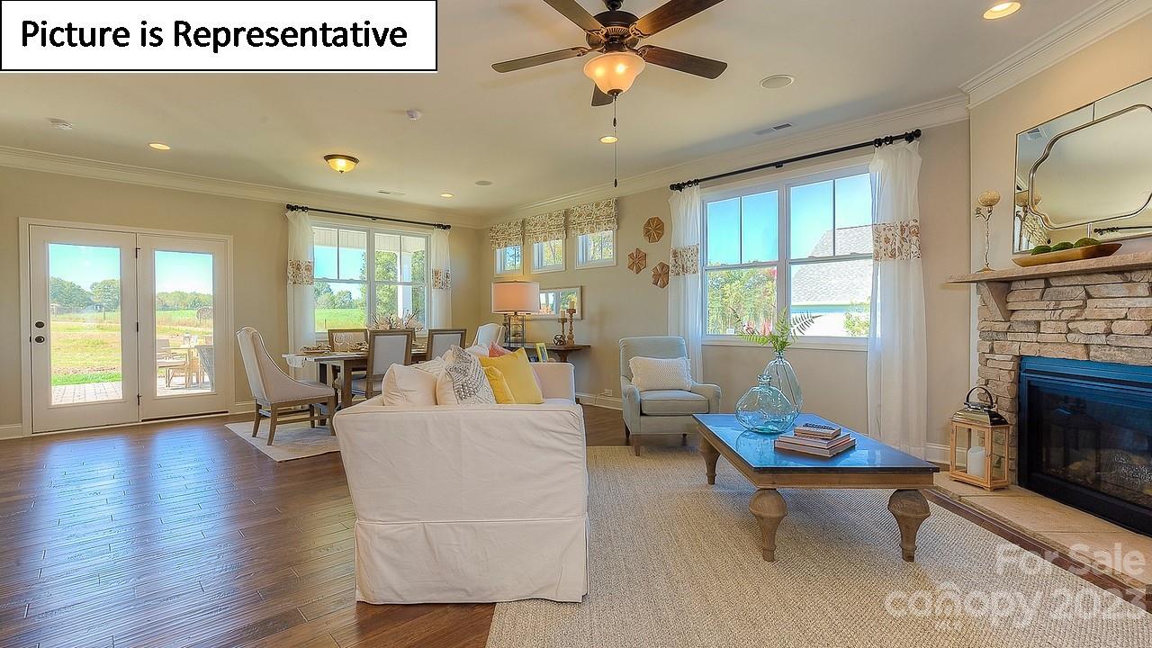 4249 Millstream Road Denver, NC 28037 - Photo 11 of 34 a living room with fireplace furniture and a large window