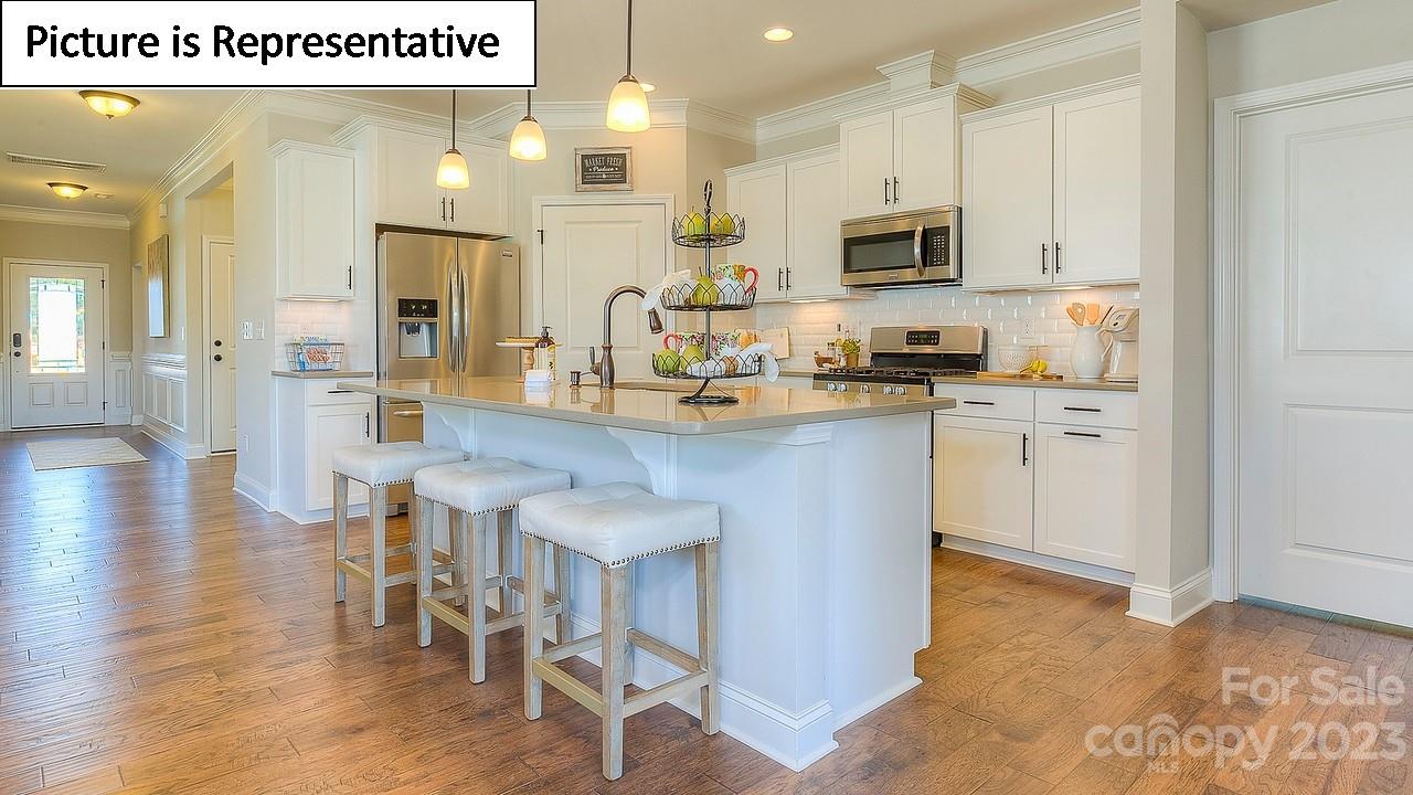 4249 Millstream Road Denver, NC 28037 - Photo 17 of 34 a kitchen with stainless steel appliances granite countertop a stove top oven a sink dishwasher and a refrigerator