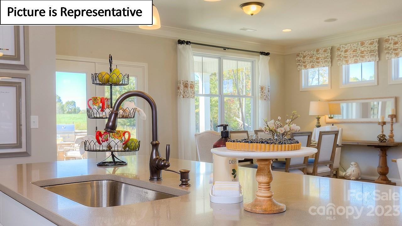 4249 Millstream Road Denver, NC 28037 - Photo 20 of 34 a kitchen with a faucet a sink and living room view