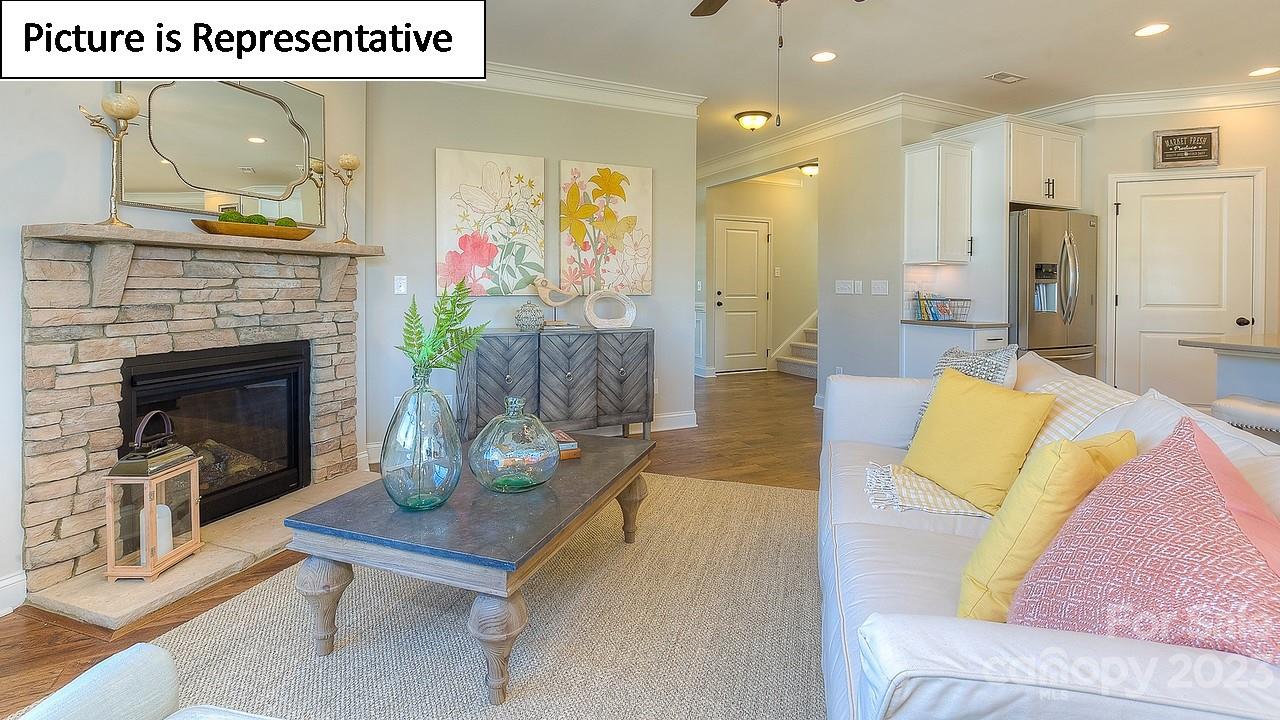4249 Millstream Road Denver, NC 28037 - Photo 21 of 34 a living room with furniture and a fireplace