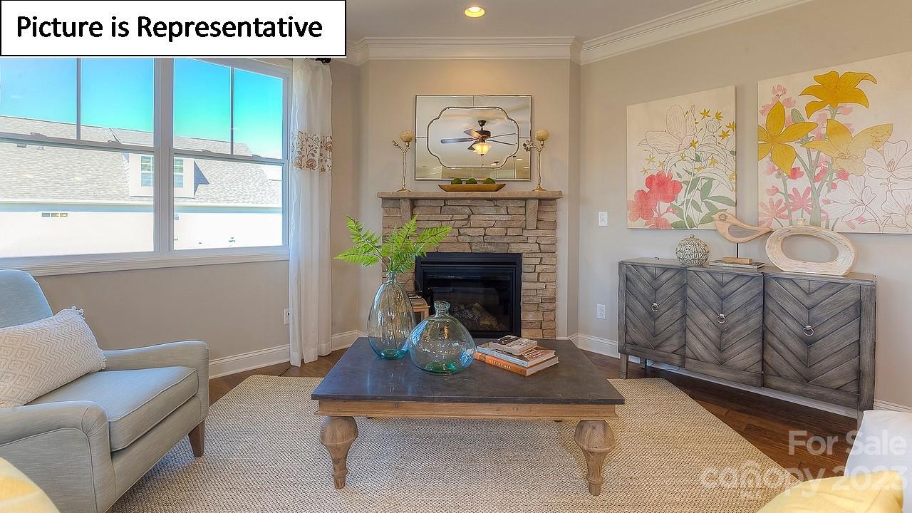 4249 Millstream Road Denver, NC 28037 - Photo 22 of 34 a living room with furniture and a fireplace