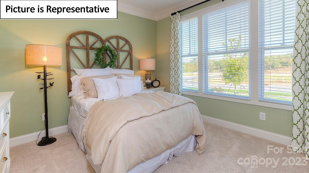 4249 Millstream Road Denver, NC 28037 - Photo 23 of 34 a bedroom with a bed and a painting on the wall