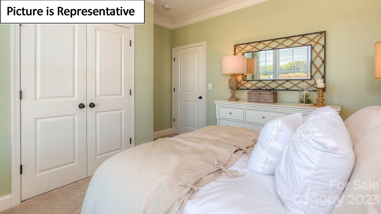 4249 Millstream Road Denver, NC 28037 - Photo 24 of 34 a spacious bedroom with a bed and a mirror