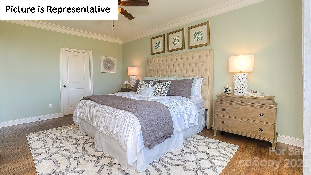 4249 Millstream Road Denver, NC 28037 - Photo 32 of 34 a bedroom with a bed and a lamp