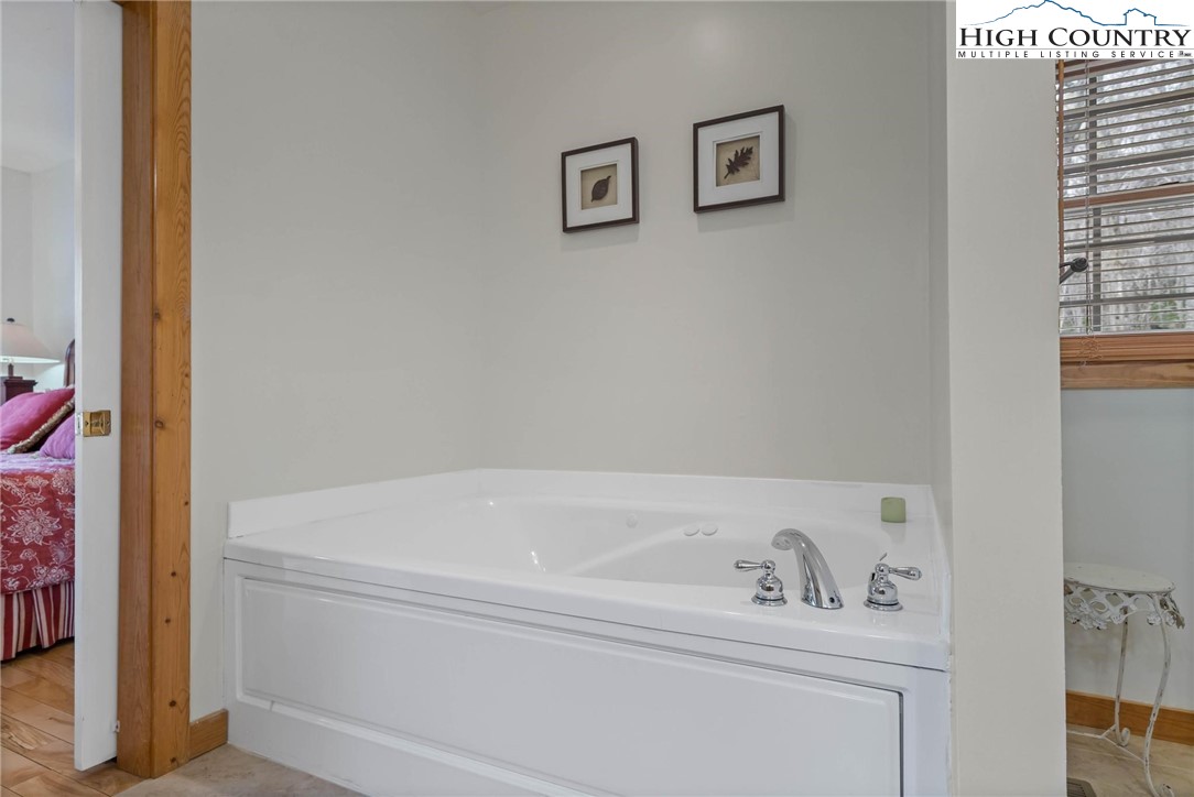 140 Spruce Hollow Road Beech Mountain, NC 28604 - Photo 19 of 50 a bathroom with a bathtub and sink