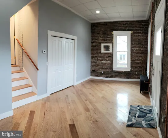 a view of a livingroom with wooden floor and stairs