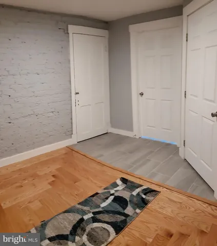 a view of a room with wooden floor