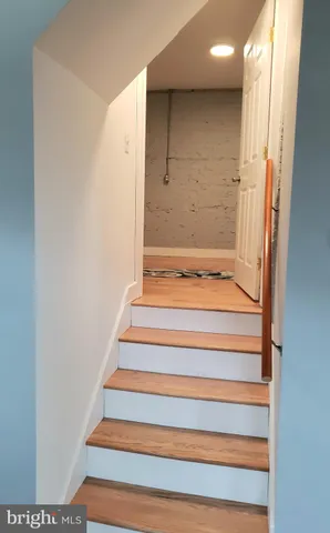 a view of staircase with white walls