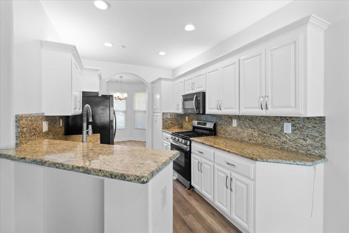478 Churchill Way Salinas, CA 93906 - Photo 7 of 31 a kitchen with stainless steel appliances granite countertop a sink stove and refrigerator