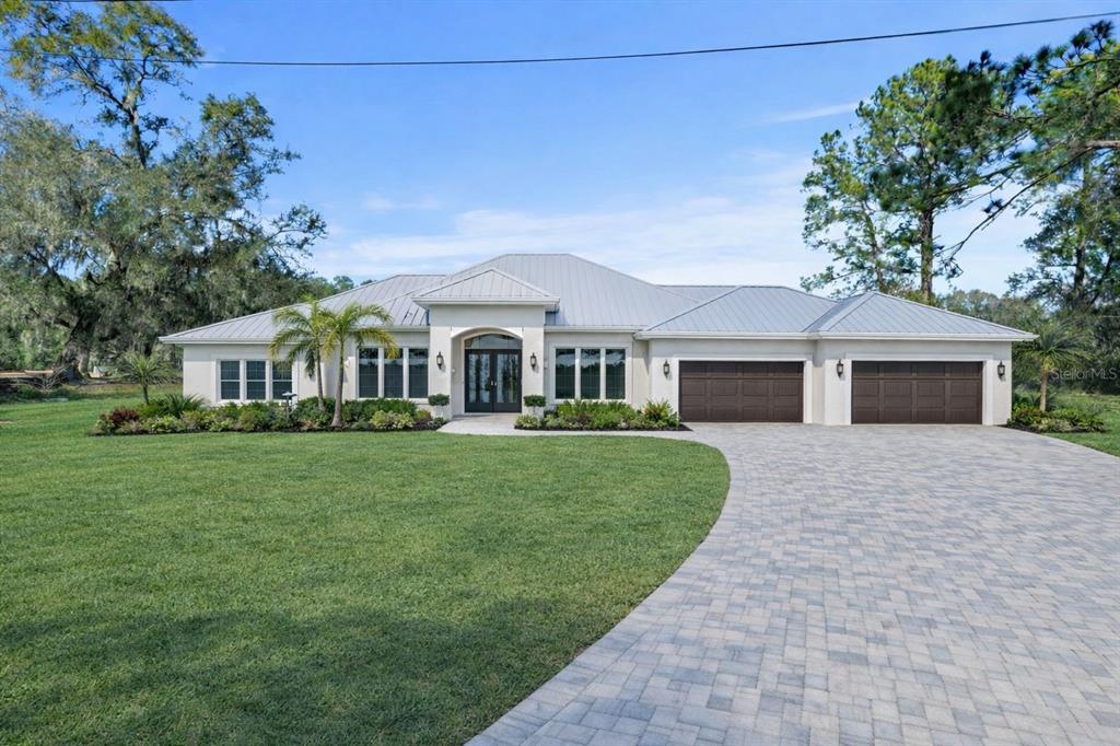 4815 Deeson Road Lakeland, FL 33810 - Photo 1 of 1 a front view of a house with a garden