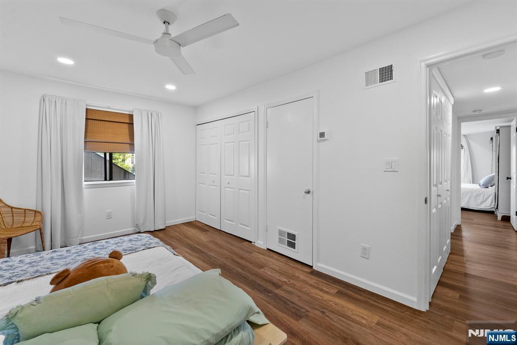 101 Highway 5, Unit 206 Edgewater, NJ 07020 - Photo 20 of 48 a bedroom with a bed and wooden floor