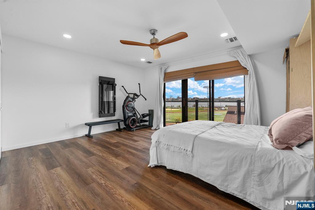 101 Highway 5, Unit 206 Edgewater, NJ 07020 - Photo 22 of 48 a bedroom with a bed and large windows