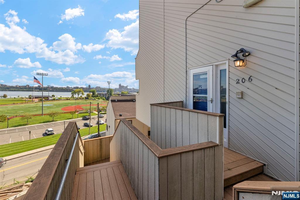 101 Highway 5, Unit 206 Edgewater, NJ 07020 - Photo 35 of 48 a view of a balcony with wooden floor and outdoor space