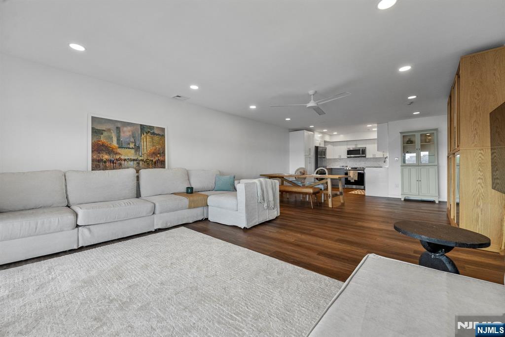 101 Highway 5, Unit 206 Edgewater, NJ 07020 - Photo 4 of 48 a living room with furniture and kitchen view