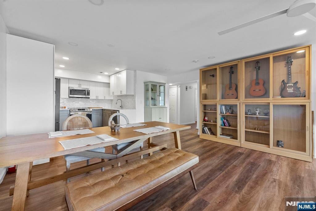 101 Highway 5, Unit 206 Edgewater, NJ 07020 - Photo 7 of 48 a living room with furniture a large window and wooden floor