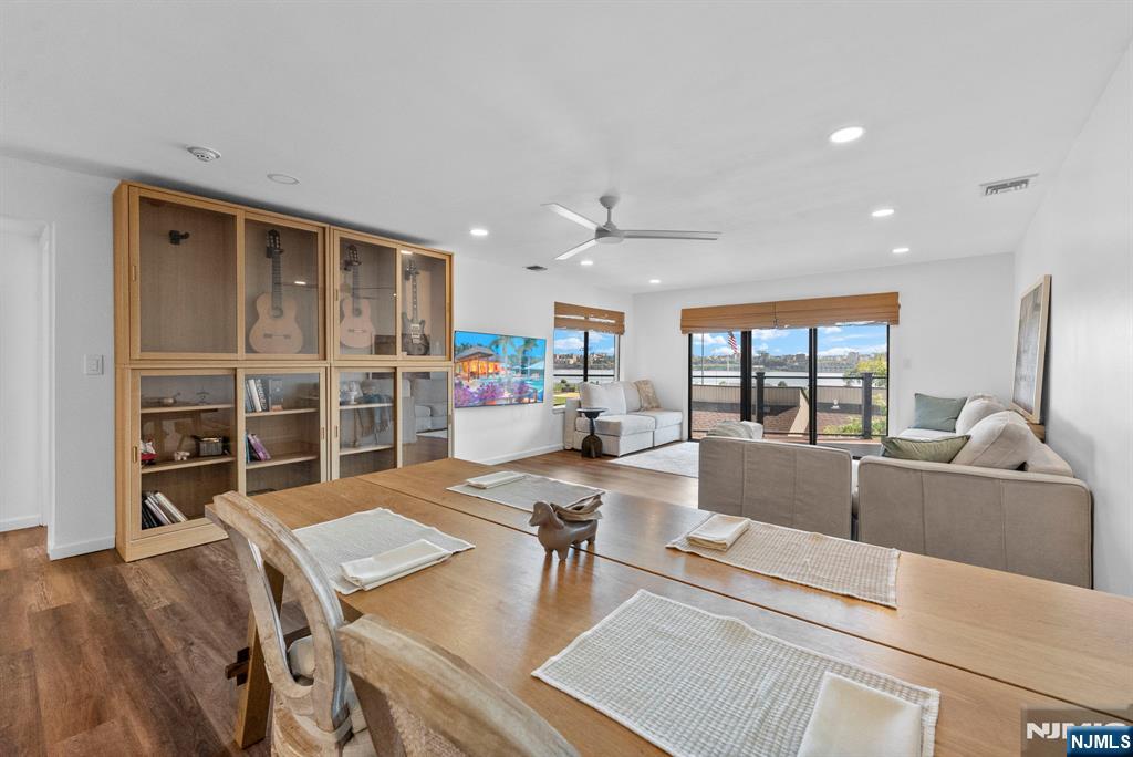 101 Highway 5, Unit 206 Edgewater, NJ 07020 - Photo 8 of 48 a living room with furniture a wooden floor and a large window