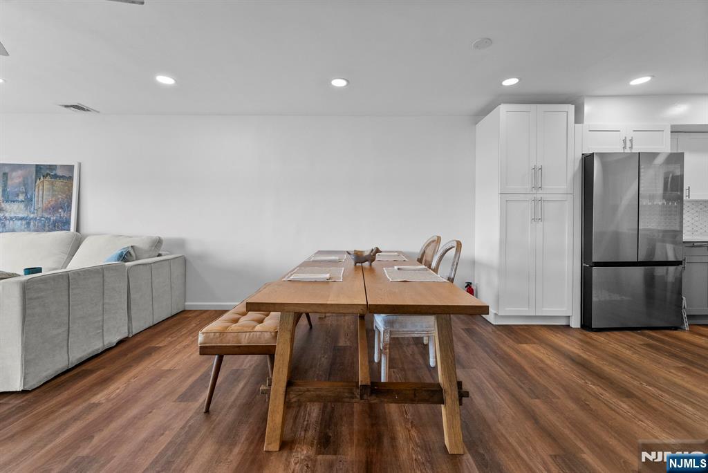 101 Highway 5, Unit 206 Edgewater, NJ 07020 - Photo 9 of 48 a view of a kitchen with a table and chairs