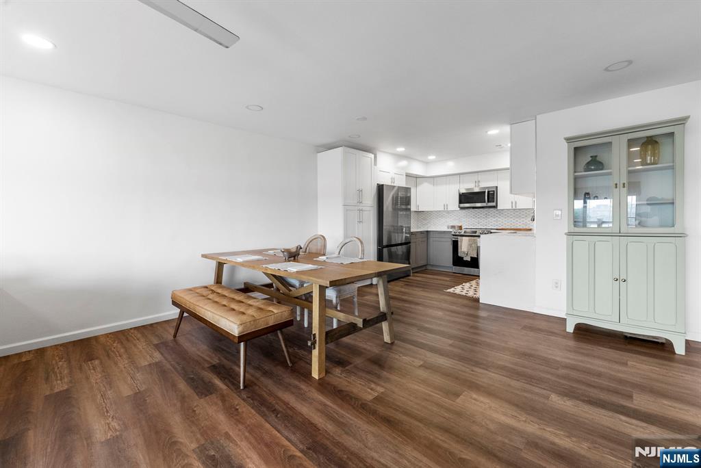 101 Highway 5, Unit 206 Edgewater, NJ 07020 - Photo 10 of 48 a dining room with furniture and wooden floor