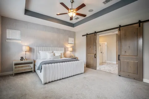 a bedroom with a bed and a chandelier