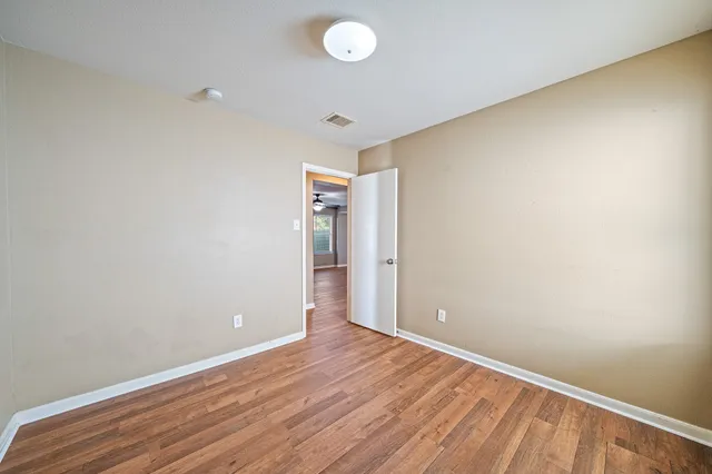 a view of room with wooden floor