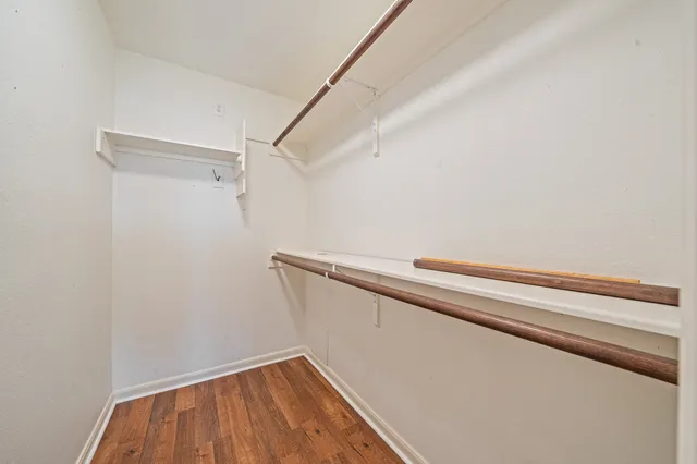 a view of a room with wooden floor