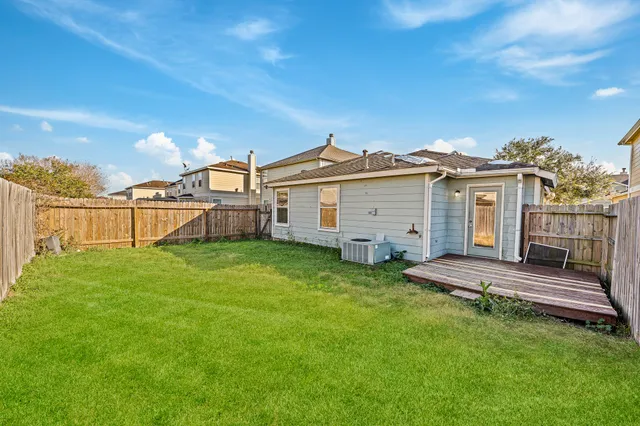 a view of a yard with a house in the background