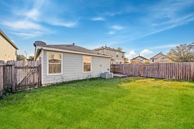 a view of a backyard with wooden fence