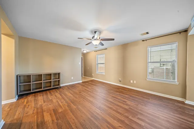 wooden floor in an empty room with a window