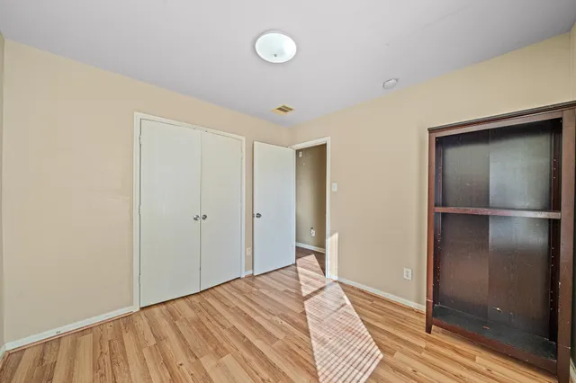 a view of a room with wooden floor