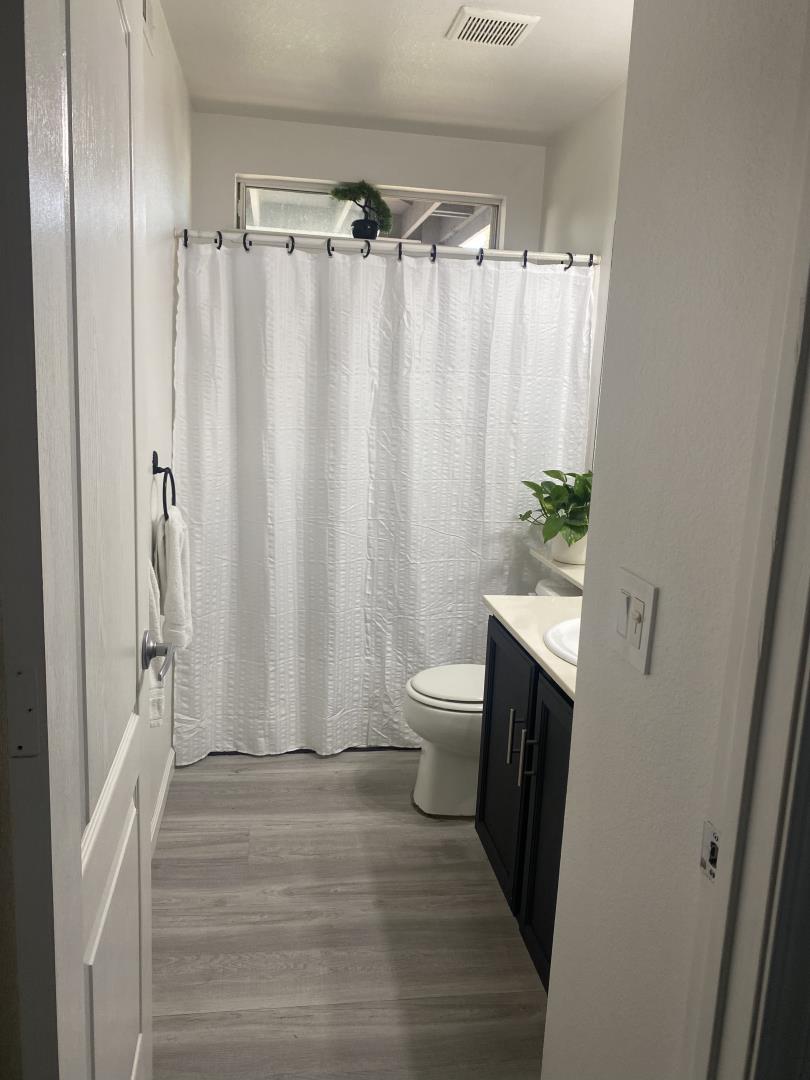 601 Fall River Drive Modesto, CA 95351 - Photo 6 of 8 a bathroom with a sink a toilet a shower curtain