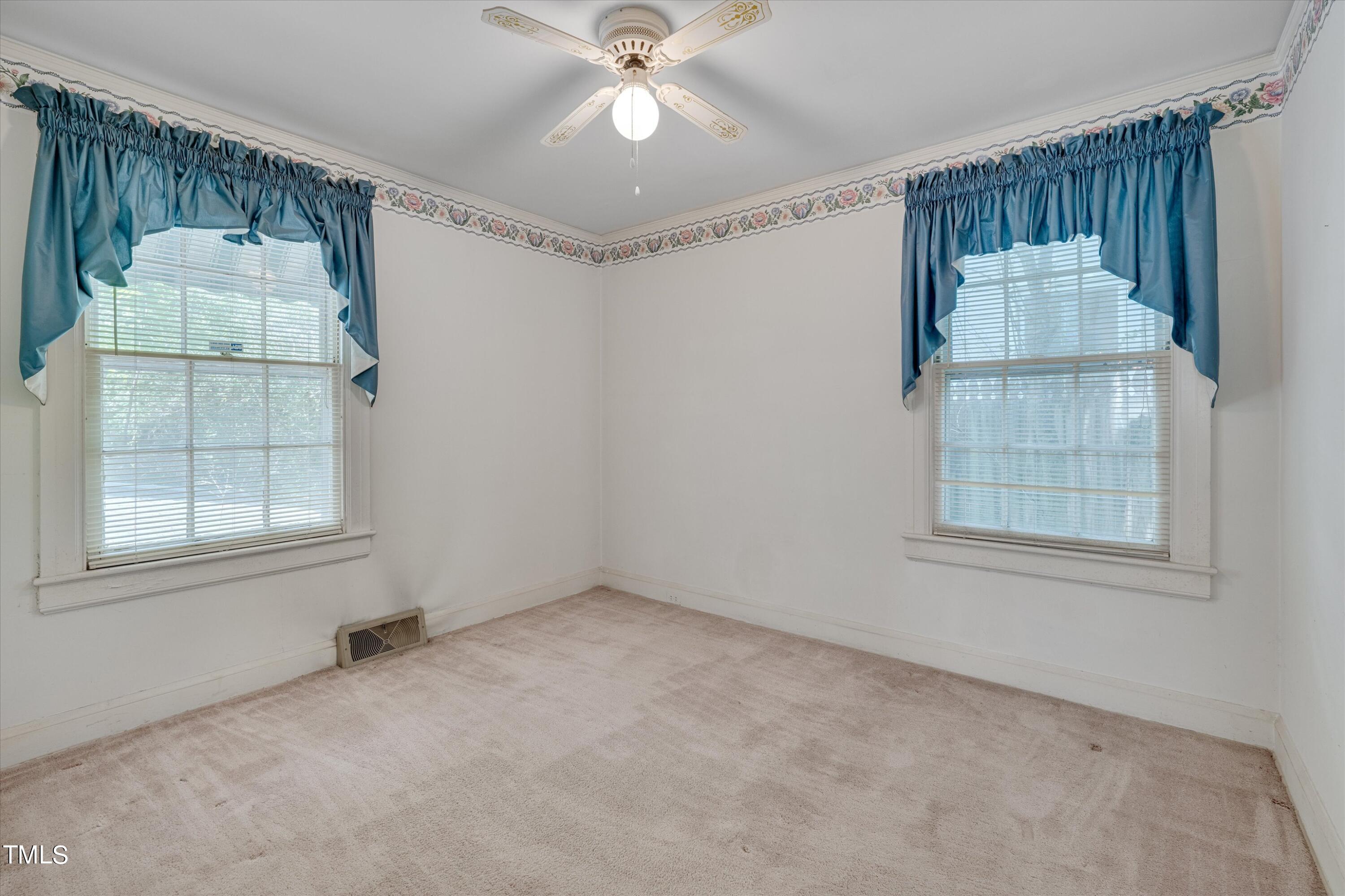 2421 Farthing Street Durham, NC 27704 - Photo 14 of 31 an empty room with chandelier fan and windows