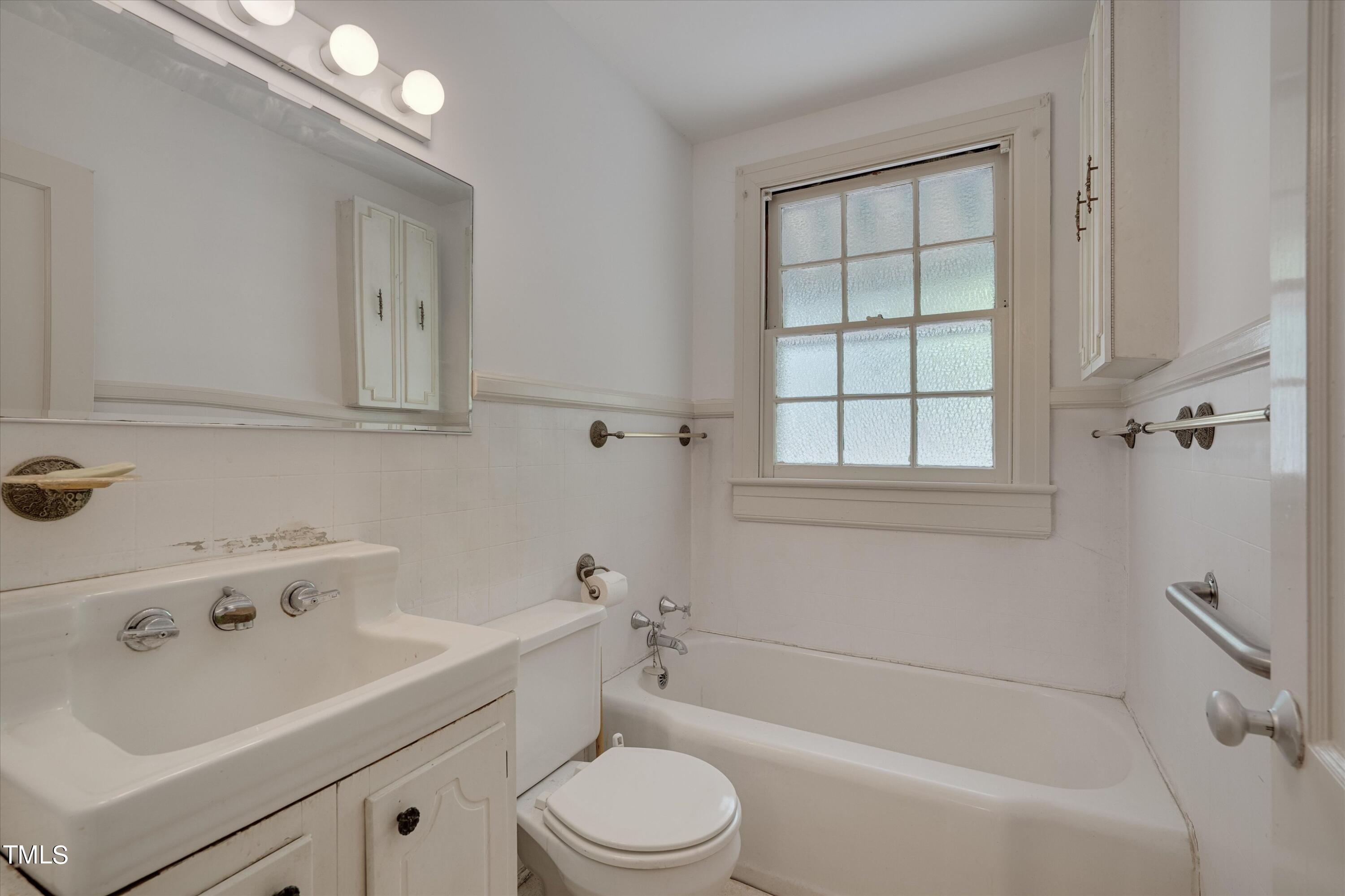 2421 Farthing Street Durham, NC 27704 - Photo 16 of 31 a bathroom with a sink a toilet and bathtub