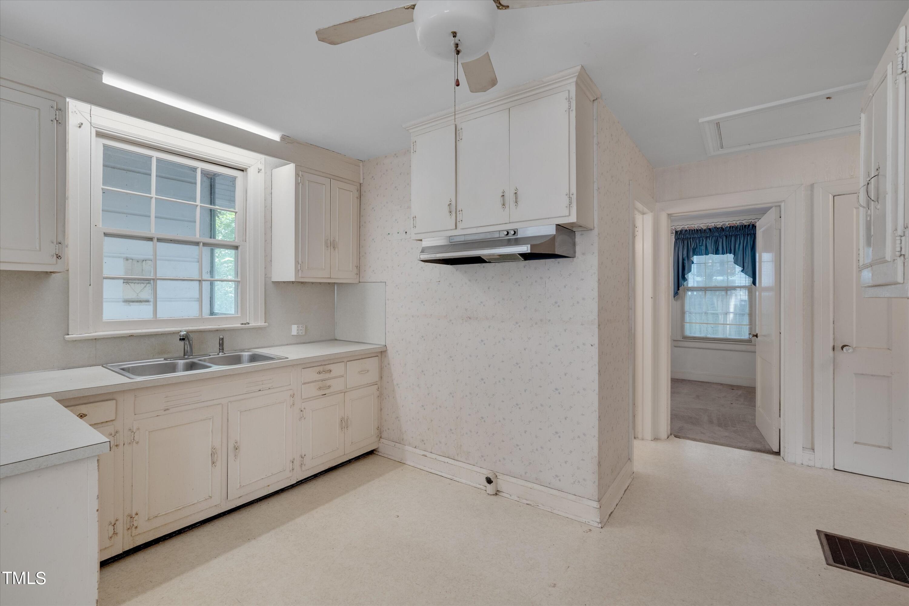 2421 Farthing Street Durham, NC 27704 - Photo 10 of 31 a view of cabinets a sink a window and a kitchen