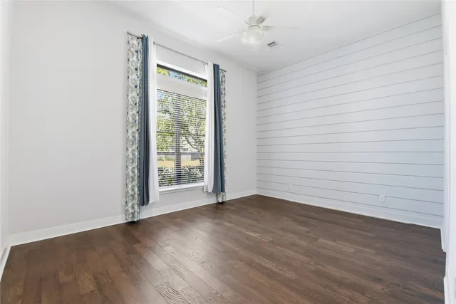 wooden floor in an empty room with a window